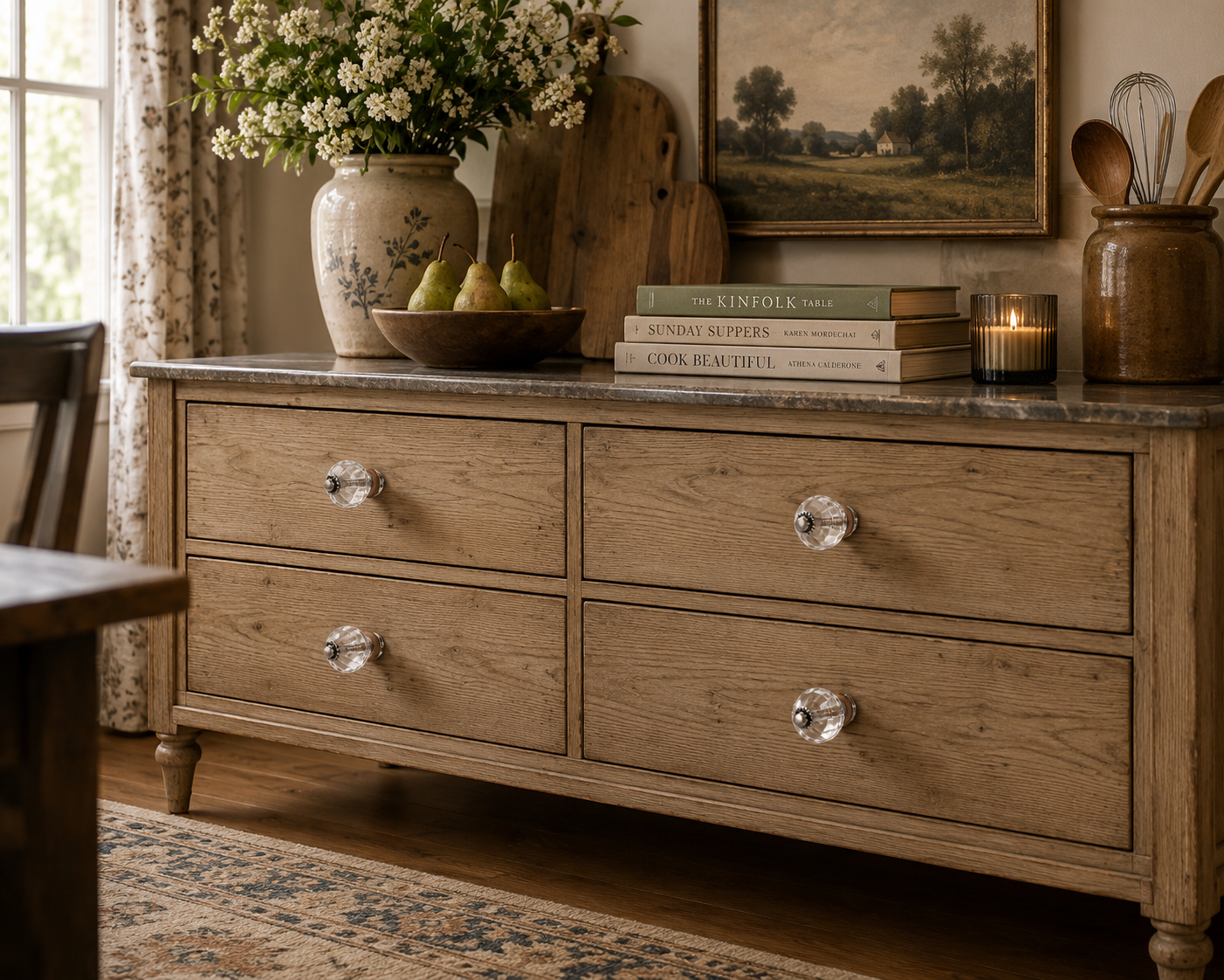 Set of clear acrylic cabinet knobs installed on a light wood dresser in a bright bedroom.