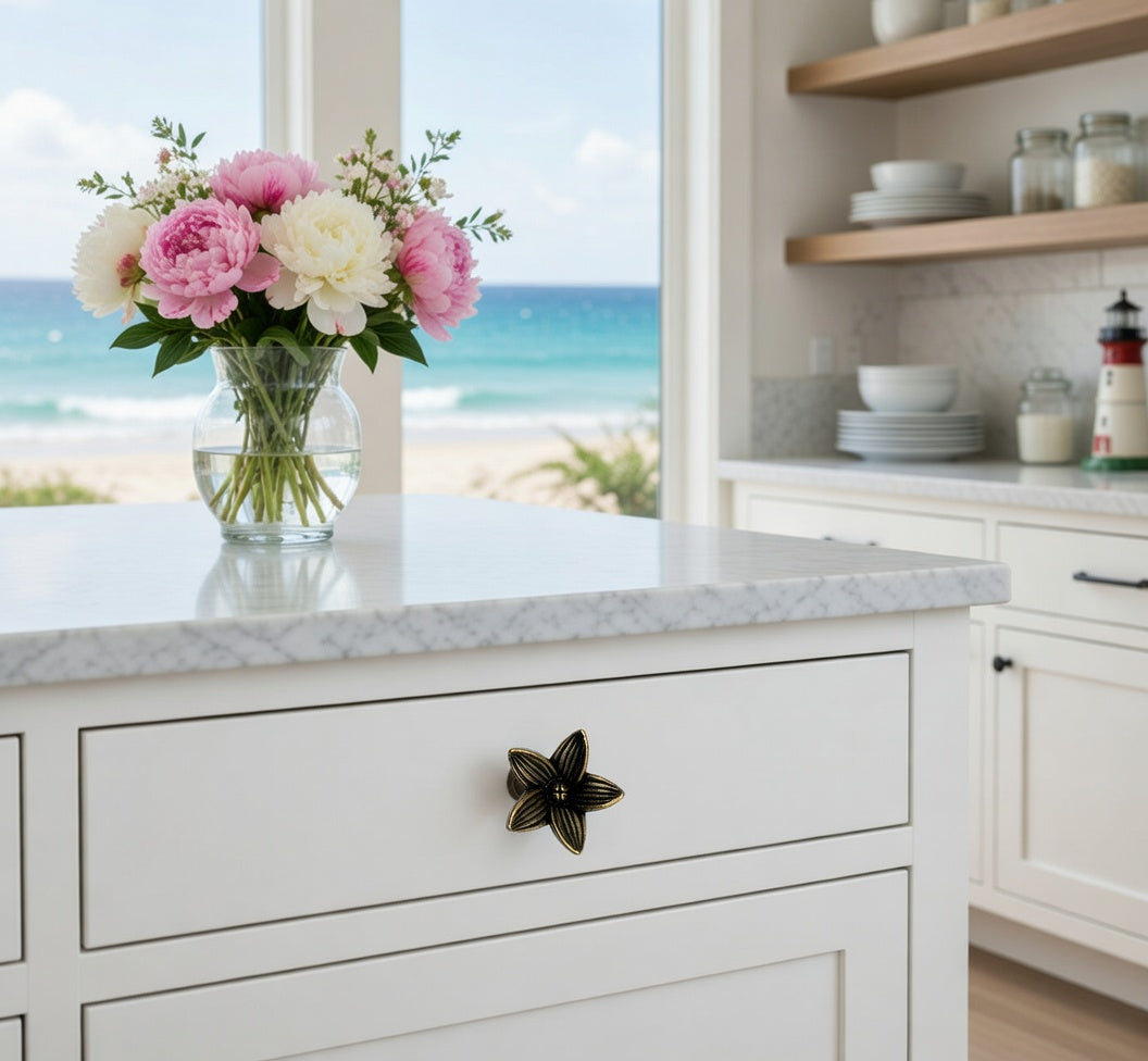 Kitchen counter with flower knob, flowers and a view of the ocean