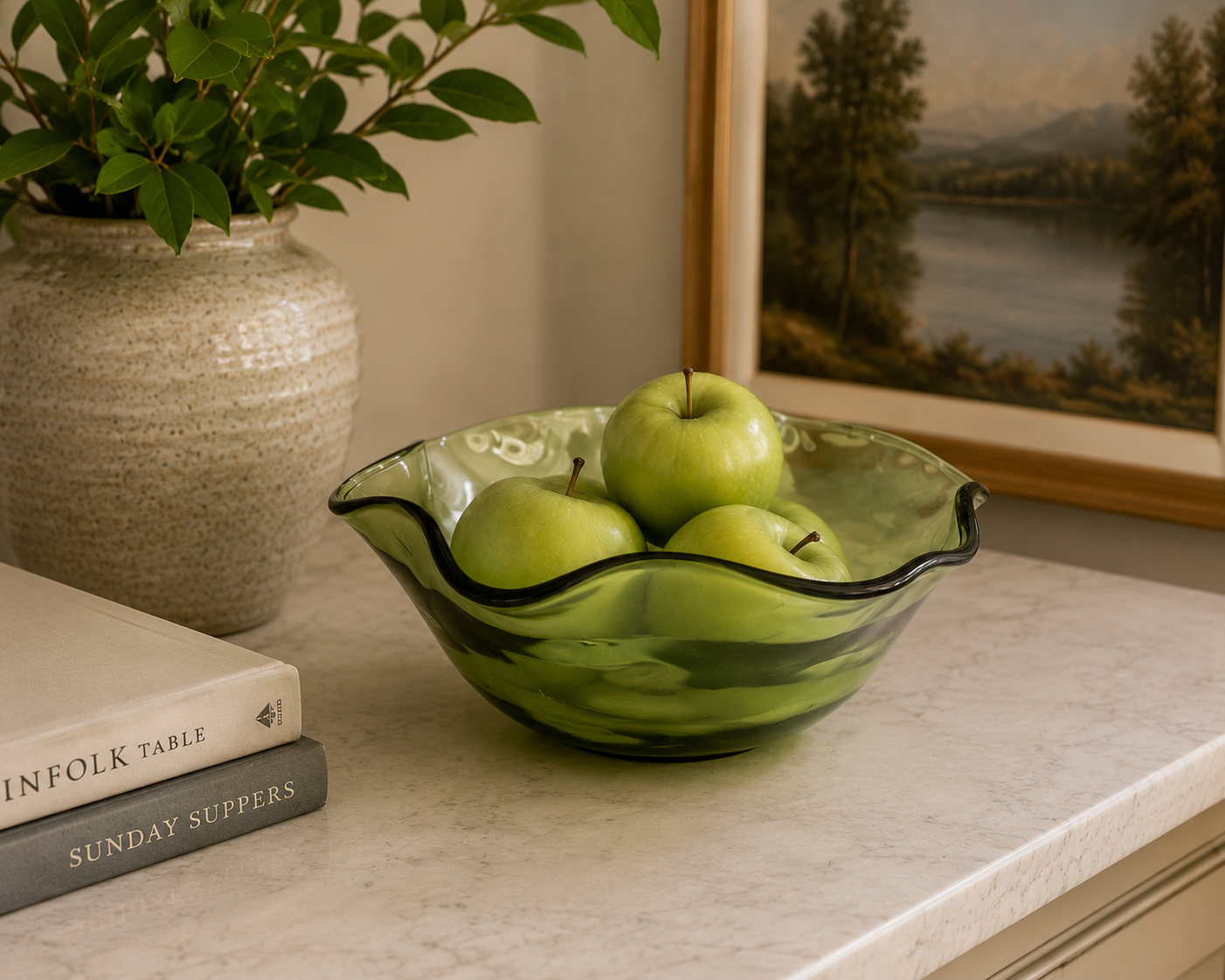 Vintage green glass bowl with scalloped edges styled on a bright kitchen counter with fresh produce.