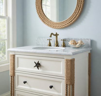 Bathroom vanity with marble countertop, gold faucet, and rope accents.